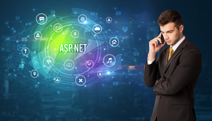 Businessman thinking in front of technology related icons and ASP.NET inscription, modern technology concept