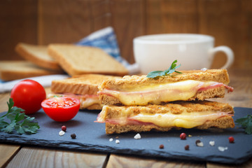 Club sandwiches for quick breakfast. Grilled or toasted sandwiches with ham salami, tomato and...
