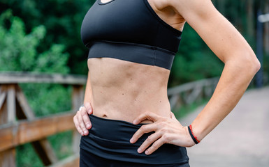 Unrecognizable athlete woman with sportswear posing outdoors