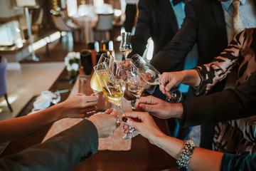 People celebrating with wine glasses