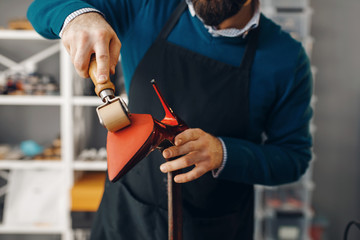 Shoemaker repairing shoe, footwear repair service