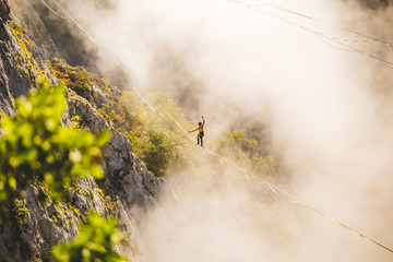 Highliner goes on a sling above the clouds.
