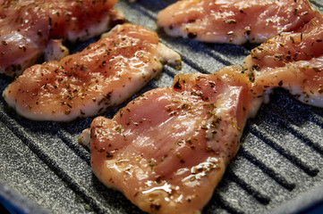 pieces of fried chicken breast. Grilled poultry steak cooked on a grill pan