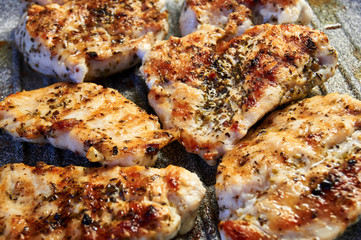 pieces of fried chicken breast. Grilled poultry steak cooked on a grill pan