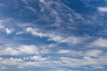 Beautiful cirrus clouds on a blue autumn sky in a frosty day. Sky pattern.