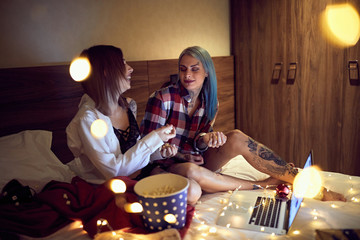 Obraz na płótnie Canvas Two lesbians spending Christmas eve together