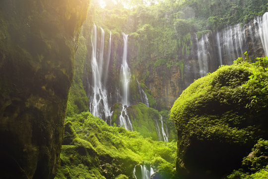 Stunning view of the Tumpak Sewu Waterfalls also known as Coban Sewu during sunrise. Tumpak Sewu Waterfalls are a tourist attraction in East Java, Indonesia.