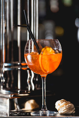 glass of refreshing orange alcoholic cocktail on a table in the bar