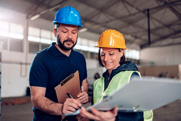 Construction worker signing document