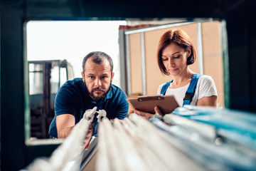 Stock clerk checking warehouse inventory