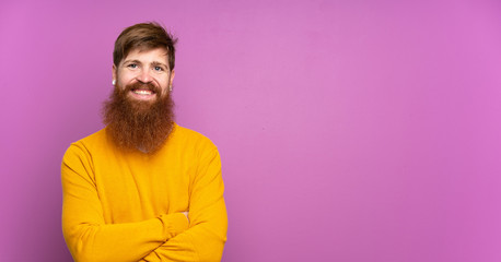 Redhead man with long beard over isolated purple background keeping the arms crossed in frontal position