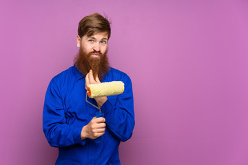 Painter man with long beard over isolated purple background