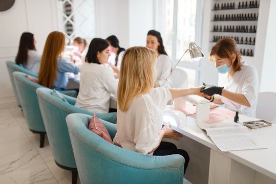 Group of girlfriends, manicure in beauty salon