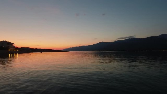 Colorful sunset pan across a peaceful Croatian bay on Adriatic coast