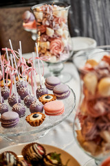 Large sweet table with many delicious and beautiful cookies and muffins