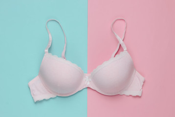 Stylish bra on pink blue background. Pastel color trend. Beauty and fashion minimalistic still life