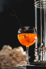 glass of refreshing orange alcoholic cocktail on a table in the bar