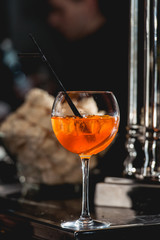 glass of refreshing orange alcoholic cocktail on a table in the bar