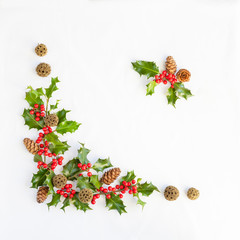 Christmas greeting card template with fresh holly with red berries arranged in opposing corner with central copy space for a holiday message