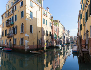 Tranquil back canal, Rio Ca Dolce in Cannaregio, Venice Italy with reflections of historic houses