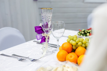 banquet table served with instruments and decorated with empty wine glasses