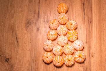 New year composition in basket with mandarins and fir tree .