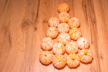 New year composition in basket with mandarins and fir tree .