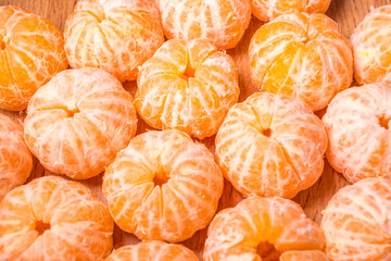 tangerines without peel on the table. background