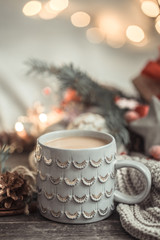 Festive background with Cup on wooden background with lights.