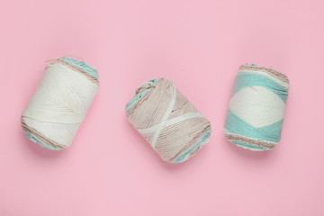 Skeins of pastel color woolen threads on pink pastel background. Housewives Hobbies.