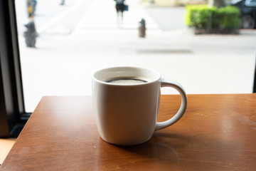 white coffee cup on wooden table
