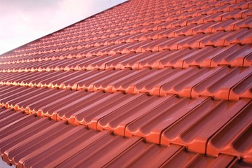 Wet red roof tiles after rain