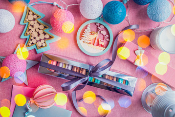 Festive decoration with macarons in the box with ribbon at the sparkling background. Perfect for Holidays.