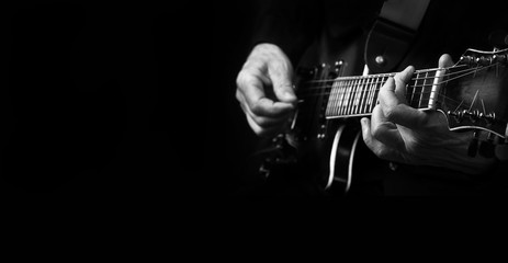 Guitarist hands and guitar close up. playing electric guitar.  black and white. copy spaces