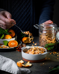 Homemade granola with quinoa, nuts and  clementines