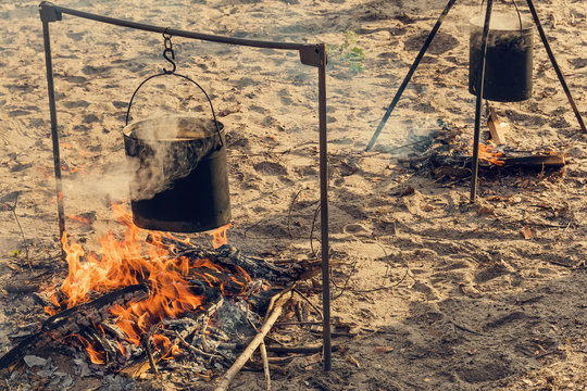 netal pot hanging over a burning fire