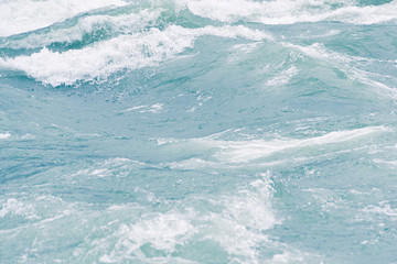 Blue ocean waves, tide. Swift current of river