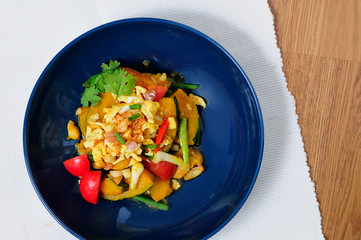 Fried pumpkin with onion eggs and tomatoes/ Top view