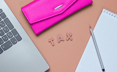 Creative flat lay business concept. Laptop, notebook with a pencil, wallet on vanilla pink...