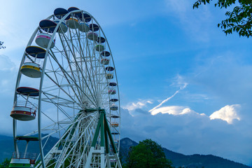 Brightly colored Ferris wheel blue sky