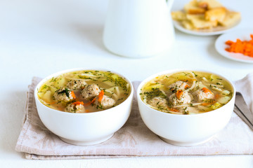 Vegetable hot soup with pasta, meat meatballs and dill greens