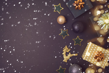 New year and Christmas background with black and gold decorations and gift boxes.