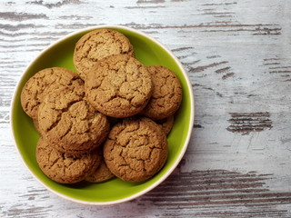  close-up of flour products, dessert, sweet crispy oatmeal round cookies on a green plate