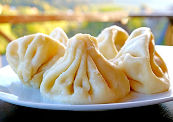 Closeup the Famous Georgian Soup Dumplings Called Khinkali on a White Plate