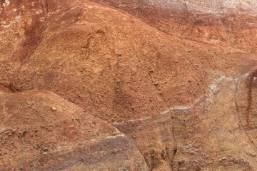 Rocks in canyon of dry river bed. Drought due to climate change. Soil erosion of hills. Red sand in mountains