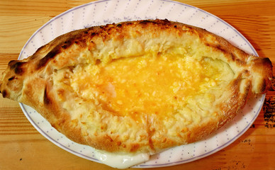Top View of Traditional Georgian Bread Called Adjaruli Khachapuri, After Mixed Cheese and Egg together