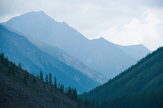 high cliffs in blue haze, silhouette of mountain range in fog, meditation and relaxation in nature