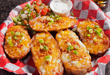 Loaded baked potatoes with cheese and topped with spring green onions
