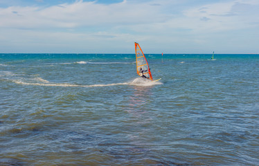 Funny windsurfing on the crystal clear water