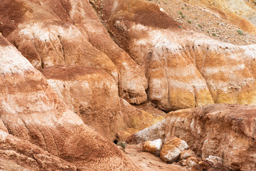 Red hills in canyon. Red colored rocks. Old bed of river in gorge